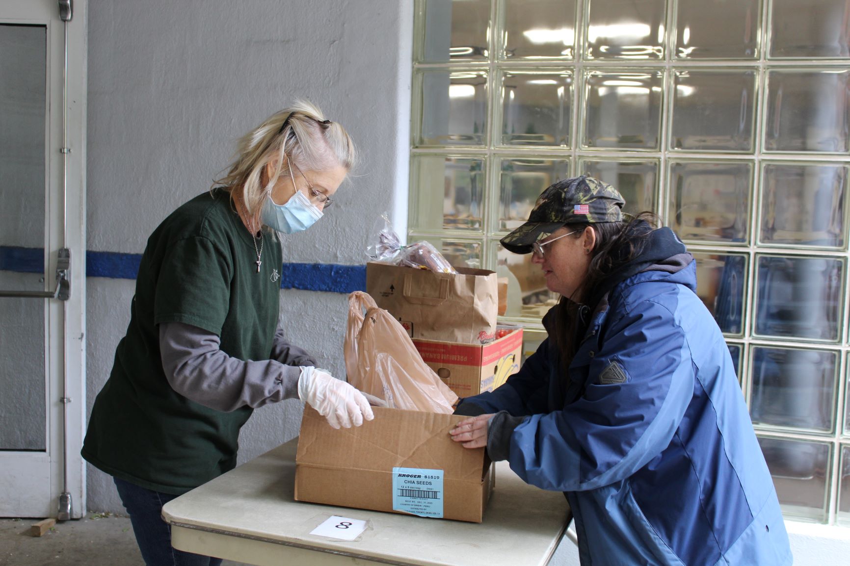 CCWVa chief executive officer, hands a box of pantry food to Sharon Rosen, a CCWVa neighbor/client.