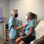 Nurse checking heartbeat on client
