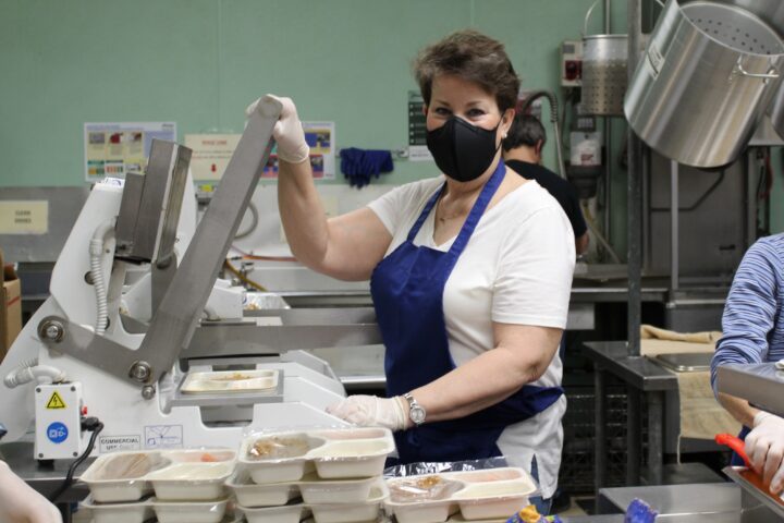Barbara Gabis operates the hot meal press to package meals for individuals who are homebound.